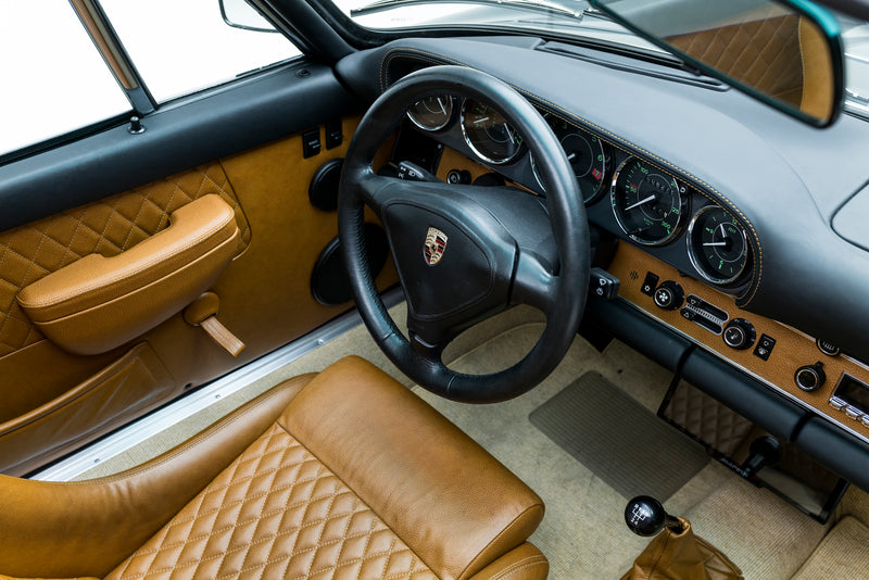 Triebwerk F3.6 interior with steering wheel and dashboard, featuring a Porsche logo.