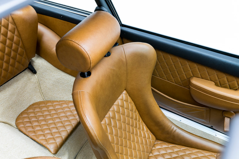 Close-up of a Triebwerk F3.6 brown leather interior with quilted design.