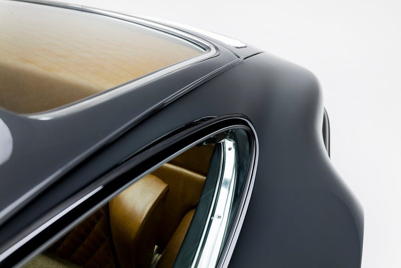 Close-up of a Triebwerk F3.6 rear window and rear fender panel on a white background