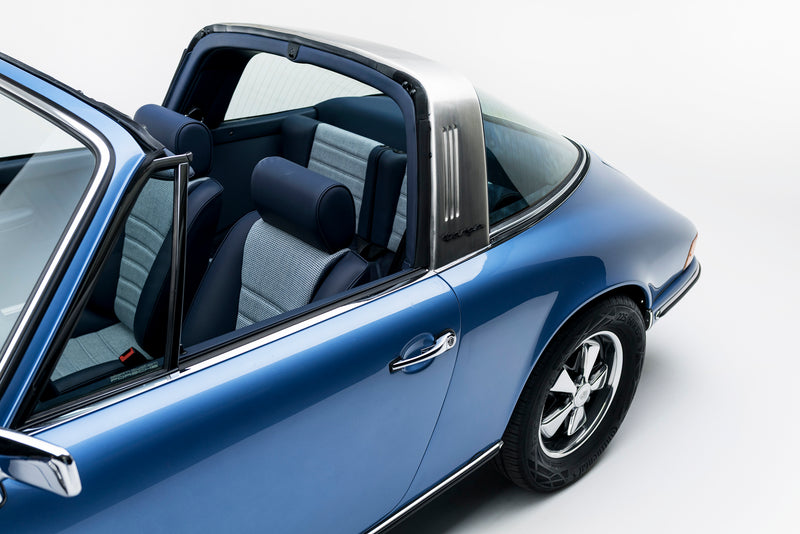 Blue Triebwerk F3.8 Targa with open door on a white background