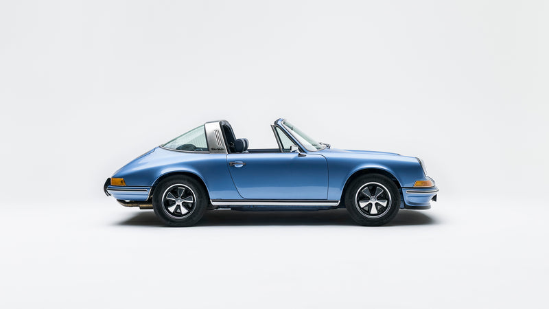 Side view of a Blue Triebwerk F3.8 Targa with targo top removed on a white background