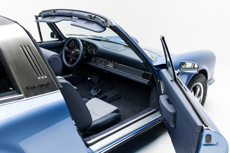 Blue Triebwerk F3.8 Targa interior with open door on a white background