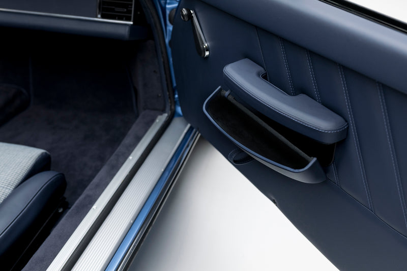 Close-up of a Blue Triebwerk F3.8 Targa door interior with handle and window controls.