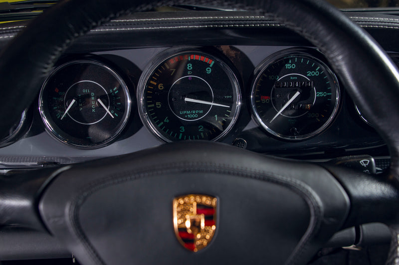 Close-up of a Triebwerk F3.8 interior dashboard with gauges and logo.