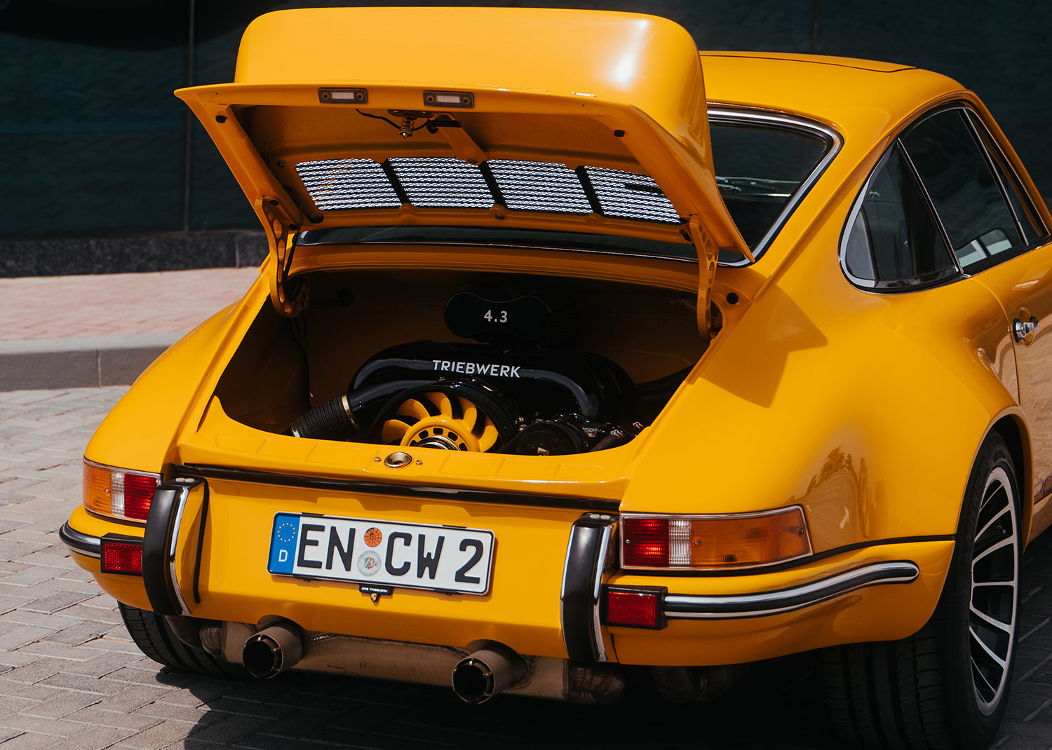Yellow Triebwerk F4.3 Porsche 911 with engine compartment open.