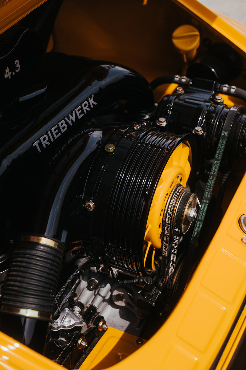 Close-up of a Triebwerk engine with visible branding on a yellow background