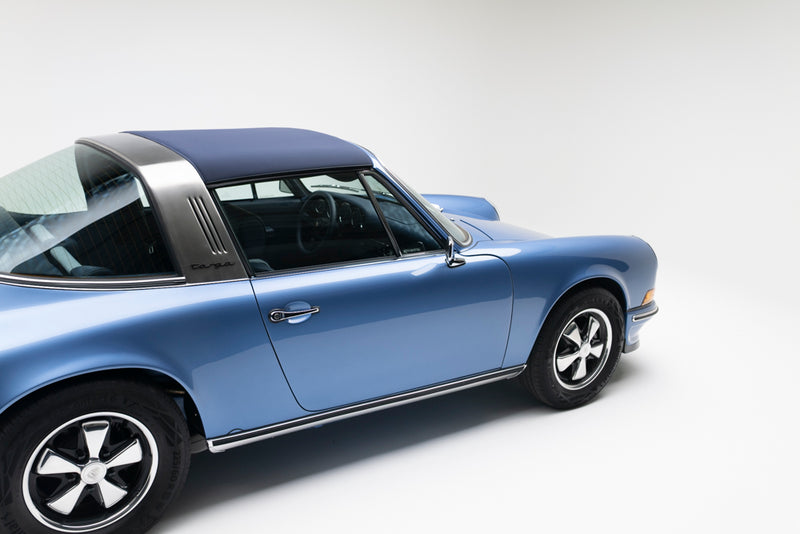 Blue Triebwerk F3.8 Targa with a targa top installed on a white background