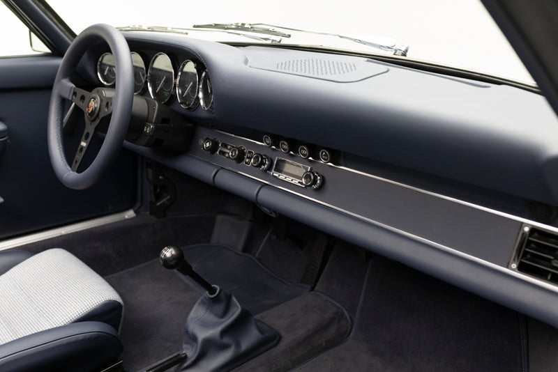Blue Triebwerk F3.8 Targa interior with steering wheel, dashboard, and gear shift.