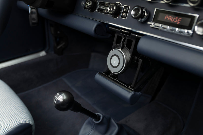 Close-up of a Blue Triebwerk F3.8 Targa gear shift and dashboard with 'PAUSE' display on stereo headunit.